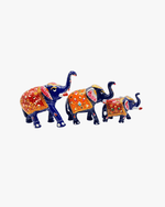 Set of 3 hand-painted royal blue metal elephants with intricate red and orange floral Meenakari work