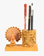Handcrafted wooden peacock pen holder desk organizer with carved design holding pens on a wooden base.