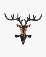 Modern deer head wall key holder with metal antlers and hooks holding keys, decorative wall-mounted organizer for entryway.