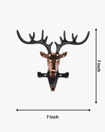 Modern deer head wall key holder with metal antlers and hooks holding keys, decorative wall-mounted organizer for entryway.