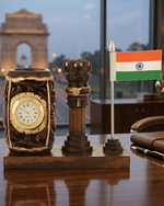 Executive wooden Ashok Stambh pen stand with clock and Indian Flag placed on a premium office desk with India Gate background.