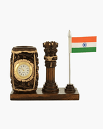 Wooden Ashok Stambh desk organizer with built-in analog clock, carved pen holder, and Indian National Flag on a solid wooden base.