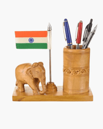 Handcrafted wooden elephant pen stand with miniature Indian national flag on white background