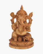 Handcrafted wooden Lord Ganesha idol sitting on lotus base with detailed carving, ideal for home decor and prayer