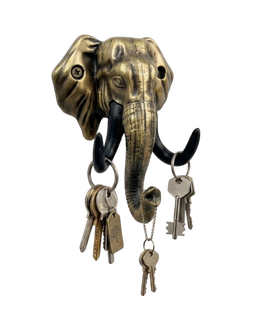 An antique gold-finished elephant head key holder set against a solid black background. Multiple sets of keys on rings hang from its black tusks and the tip of its curled trunk