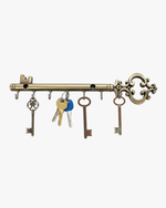 Antique brass decorative key holder rack with multiple keys hanging on hooks