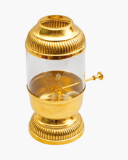 Open brass Akhand diya showing cotton wick mechanism and glass cover