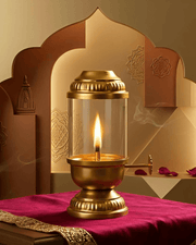 Brass Akhand diya with glass cover placed on a red cloth with decorative background arch