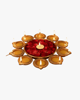 Brass urli decorated with candles and rose petals for Diwali festive decoration