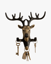 Decorative deer head key holder with multiple hooks holding keys, elegant wall organizer