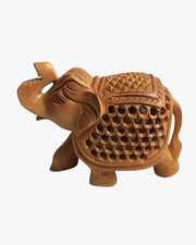 Decorative wooden elephant figurine with raised trunk and intricate handmade carving