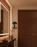 Decorative elephant key holder mounted on wall beside mirror and wooden console table in modern interior