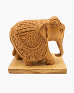 Hand carved wooden elephant figurine featuring traditional floral motifs and solid base