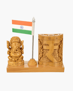 Clean studio shot of handcrafted wooden Lord Ganesha desk organizer stand with Indian flag and carved pen holder.