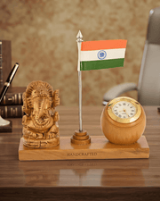 Wooden Ganesha table top with Indian tricolor flag and clock placed on executive wooden desk