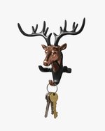 Modern metal deer head key holder with hooks holding keys, stylish wall-mounted home decor organizer