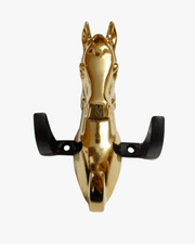 Close-up of metal horse head key holder with multiple hooks and keys hanging
