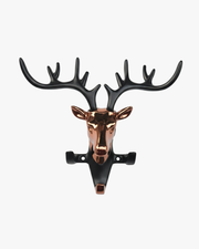 Modern deer head wall key holder with metal antlers and hooks holding keys, decorative wall-mounted organizer for entryway.