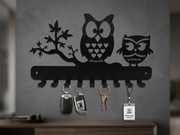 Black metal owl family key holder with 9 hooks displayed on a plain white background
