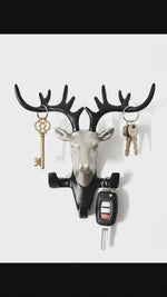 Decorative deer head wall mounted key holder with antler hooks holding house keys and car key remote