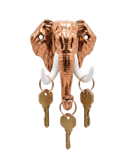 A shiny copper-colored elephant head key holder against a black background. It features contrasting white tusks with several single brass keys hanging from keyrings on each tusk and the trunk