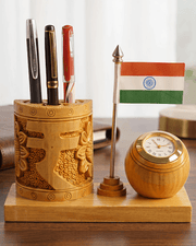 Front view of handcrafted wooden desk organizer featuring carved Rupee symbol, pen holder, clock, and Indian flag