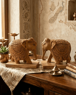 Pair of hand carved wooden elephant statues arranged on table for living room decor