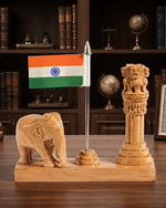 Wooden Indian tricolor flag stand featuring Ashok Stambh and carved elephant displayed on a wooden executive office desk in front of a bookshelf.