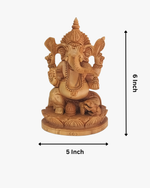 Hand carved wooden Lord Ganesha idol with detailed traditional design